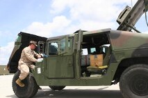 Hospital Corpsman Alex Peeler inspects a humvee during a limited technical inspection aboard Marine Corps Support Facility Blount Island, Fla., May 28, 2013. Peeler was taught a variety of Marine Corps jobs during a Marine Prepositioning Force exercise aboard Blount Island with Marines from II Marine Expeditionary Force. (U.S. Marine Corps photo by Lance Cpl. Shawn Valosin)