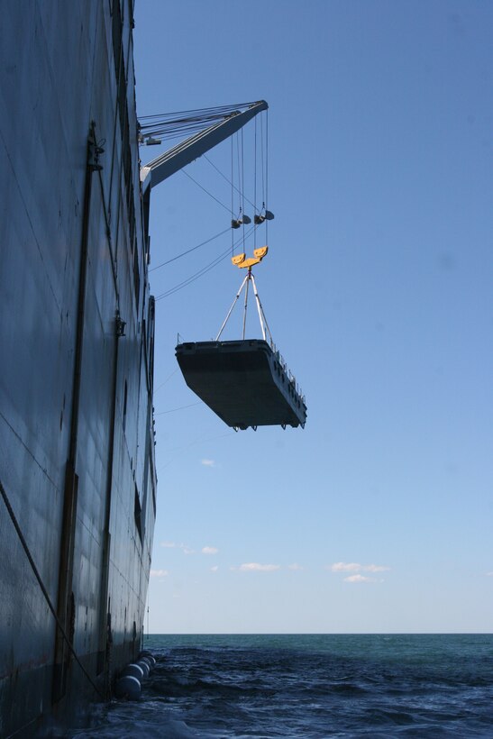 A navy lighterage vessel is lowered from the United States Naval Ship Dahl during a Marine Prepositioning Force exercise, May 25, 2013. The lighterage was used to move equipment from the USNS Dahl to service members aboard Marine Corps Support facility Blount Island, Fla. (U.S. Marine Corps photo by Lance Cpl. Shawn Valosin)