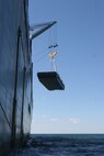 A navy lighterage vessel is lowered from the United States Naval Ship Dahl during a Marine Prepositioning Force exercise, May 25, 2013. The lighterage was used to move equipment from the USNS Dahl to service members aboard Marine Corps Support facility Blount Island, Fla. (U.S. Marine Corps photo by Lance Cpl. Shawn Valosin)