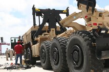 Service members from the II Marine Expeditionary Force conduct joint limited technical inspections on vehicles with contractors aboard Marine Corps Support Facility Blount Island, Fla.,May 29, 2013. Joint inspections were the culminating event of a Marine Prepositioning Force exercise conducted on the base. (U.S. Marine Corps photo by Lance Cpl. Shawn Valosin)