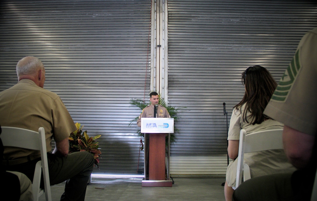 Miami-Dade Police Officer Sgt. David Dominguez speaks of his respect for Marine Lance Cpl. Colton Rusk during a dedication ceremony at Miami International Airport May 31, 2013. . Miami-Dade Police and the Transportation Security Administration memorialized Rusk, who was killed by a sniper while serving in Afghanistan as a dog handler, by naming their new canine training center in his memory. Dominguez was motivated to honor Rusk after being assigned a canine from the Department of Defense’s breeding program named after Rusk. CColton, the newest explosive detection dog at MIA, was certified during the ceremony. 