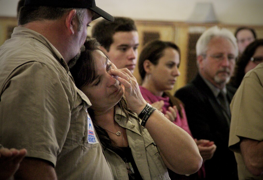 Kathy Rusk, the mother of Marine Lance Cpl. Colton Rusk, wipes away tears during a dedication ceremony in her son’s honor at Miami International Airport May 31, 2013. Miami-Dade Police and the Transportation Security Administration memorialized Rusk, who was killed by a sniper while serving in Afghanistan as a dog handler, by naming their new canine training center in his memory. County officials also issued a proclamation making the Rusk family honorary residents of Miami-Dade County.