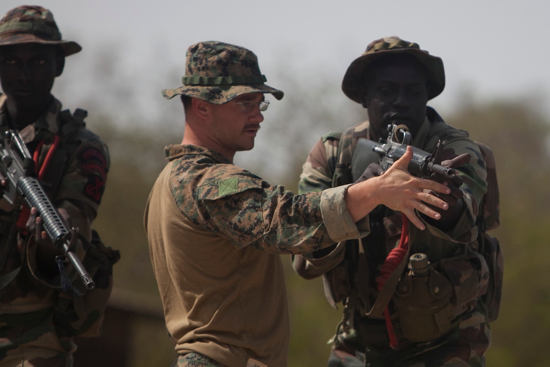 Sgt. James Jones, Special-Purpose Marine Air-Ground Task Force Africa 13 reconnaissance Marine from Napa, Calif., instructs a Senegalese Companie de Fusilier Marine Commando on fundamentals of combat marksmanship in Toubacouta, Senegal, April 22, 2013. Marines and Sailors with Special-Purpose MAGTF Africa 13 were recently in Senegal working with Companie de Fusilier Marine Commandos on combat marksmanship, maritime security and light infantry operations. Special-Purpose MAGTF Africa strengthens U.S. Marine Corps Forces Africa and U.S. Africa Command's ability to assist partner nations. The approximately 150 U.S. Marines and Sailors conduct security force assistance, military-to-military engagements and are trained to provide support to crisis response. 