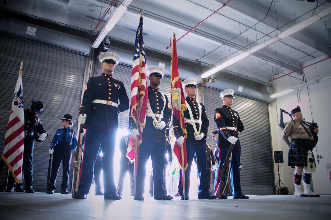 A Marine Corps color guard with 8th Tank Battalion, 4th Marine Division, Marine Forces Reserve, waits to honor Lance Cpl. Colton Rusk during a dedication ceremony at Miami International Airport May 31, 2013. Miami-Dade Police and the Transportation Security Administration memorialized Rusk, who was killed by a sniper while serving in Afghanistan as a dog handler, by naming their new canine training center in his memory. County officials also issued a proclamation making the Rusk family honorary residents of Miami-Dade County. 