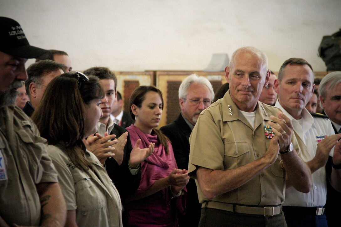 Marine Corps Gen. John F. Kelly, commander of the United States Southern Command, applauds the family of Lance Cpl. Colton Rusk during a dedication ceremony at Miami International Airport May 31, 2013. Miami-Dade Police and the Transportation Security Administration memorialized Rusk, who was killed by a sniper while serving in Afghanistan as a dog handler, by naming their new canine training center in his memory. County officials also issued a proclamation making the Rusk family honorary residents of Miami-Dade County.