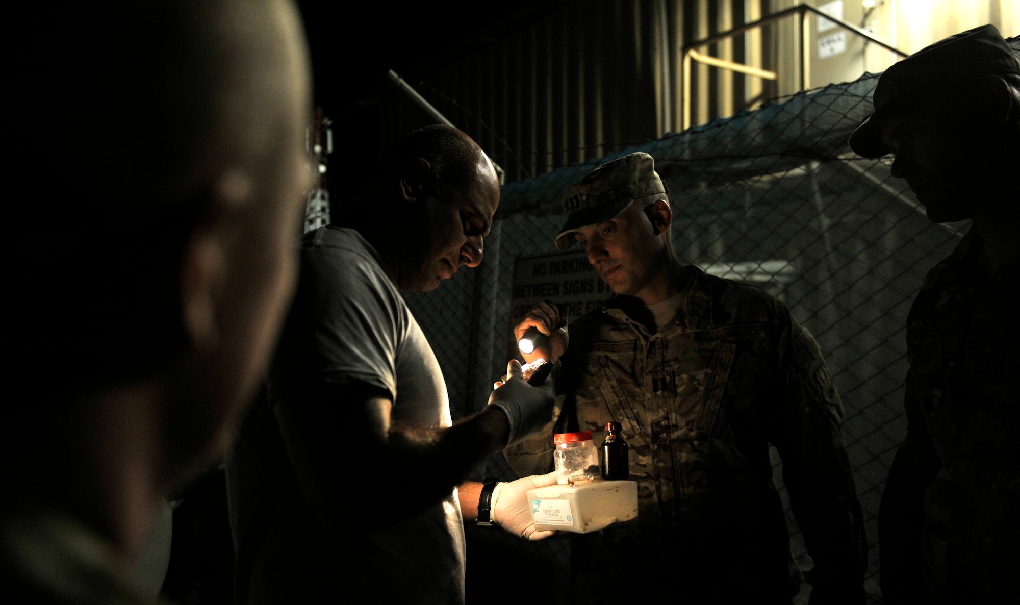 Anti-Terrorism and Force-Protection members examine a suspicious item found during a Task Force Colonist event on Bagram Airfield, Afghanistan, May 30. After a volunteer conducts a search and identifies suspicious items, they bring them to AT/FP personnel for review and if necessary, further investigation.   Task Force Colonist is a force protection tool used to conduct random camp sweeps of third country national employee living quarters for illegal items such as drugs, weapons, unauthorized uniform items, and/or electronic devices. (U.S. Air Force photo/ Staff Sgt. Stephenie Wade)