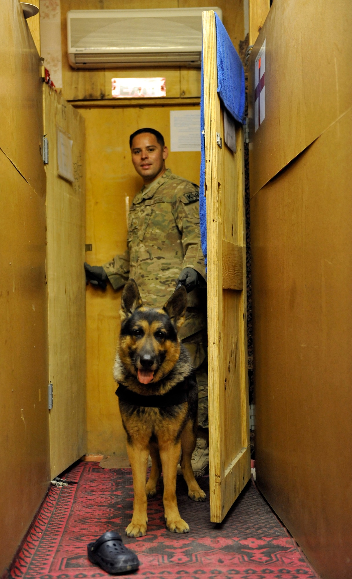 Staff Sgt. Max Soto, 455th Expeditionary Security Force Group, military dog handler, searches third country national employee living quarters for drugs and other illegal items during a Task Force Colonist event on Bagram Airfield, Afghanistan, May 30.  His primary role during Task Force Colonist is to look for narcotics, but he and his dog also search for other contraband.  Soto is deployed from McConnell Air Force Base, Kan. (U.S. Air Force photo/ Staff Sgt. Stephenie Wade)