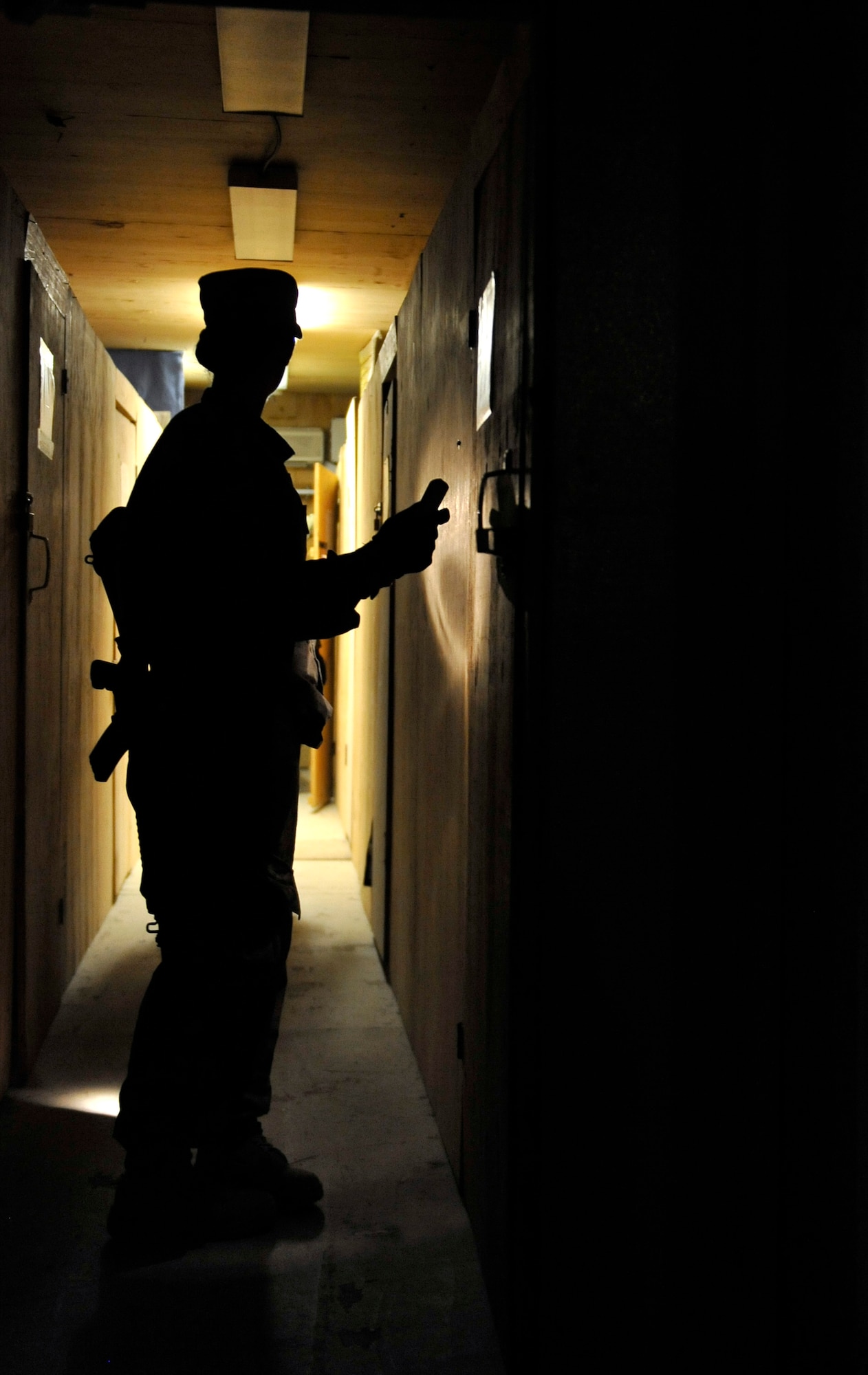 Senior Airman Michelle Saucier knocks on a resident’s B-hut door prior to searching it for unauthorized items on Bagram Airfield, Afghanistan, May 30. Task Force Colonist is a force protection tool used to conduct random camp sweeps of third country national employee living quarters looking for illegal items such as drugs, weapons, unauthorized uniform items, and/or electronic devices.  (U.S. Air Force photo/ Staff Sgt. Stephenie Wade)
 
