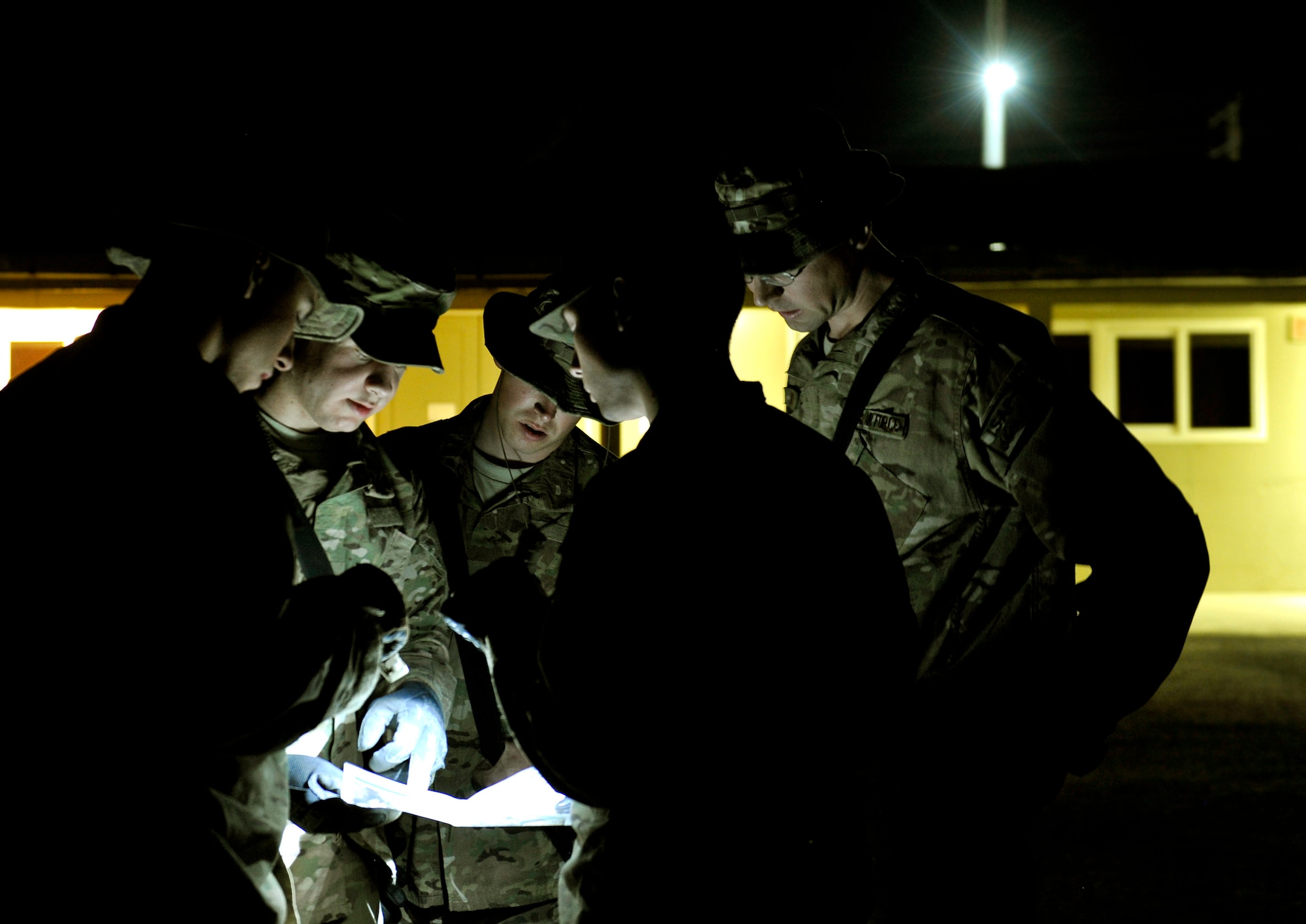 Task Force Colonist volunteers look at a compound map prior to searching it for unauthorized items on Bagram Airfield, Afghanistan, May 30. The 120 volunteers contributed to decreasing the amount of contraband on the base by participating in this ongoing force protection program. (U.S. Air Force photo/ Staff Sgt. Stephenie Wade)