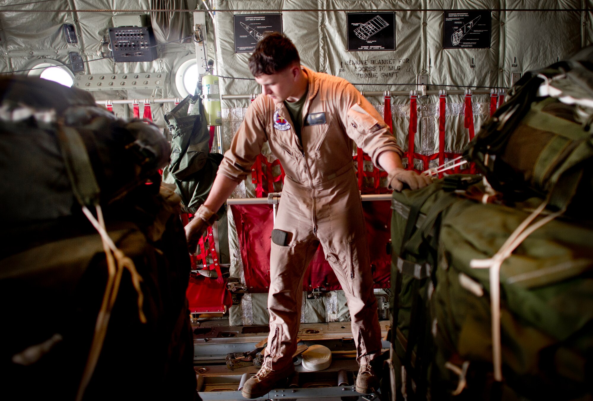 YOKOTA AIR BASE, Japan -- Cpl. Brook Cannon, loadmaster with Marine Airlift Group 36, Iwakuni, Japan, secures low velocity container delivery systems aboard  a C-130 May 29, 2013 at Yokota Air Base, Japan. Cannon along with other members from joint services are at Yokota for Airborne Tomahawk, a training exercise to evaluate rigging and movement procedures and execute airdrop resupply. (U.S. Air Force photo by Staff Sgt. Stacy Moless)  