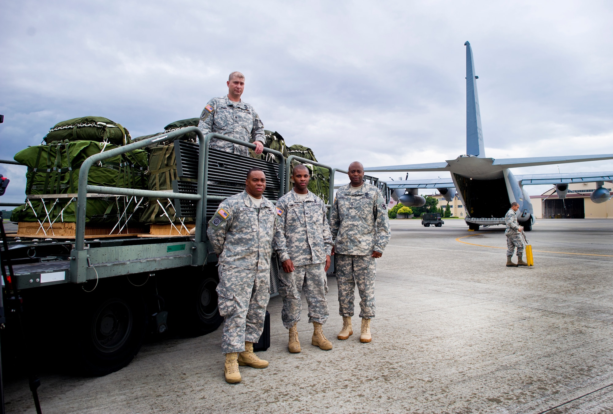 YOKOTA AIR BASE, Japan -- Army members with the 4 th Quartermaster Detachment, Army Field Support Battalion and the 8 thTheater Sustainment Command, stand with low velocity container delivery system bundles May 29, 2013 at Yokota Air Base, Japan. The bundles will be loaded on to a C-130 with aircrew from the Marine Airlift Group 36, Iwakuni, Japan during exercise Airborne Tomahawk. During the training, members from the 36th Airlift Squadron work with the other services to evaluate rigging and movement procedures and execute airdrop resupply. (U.S. Air Force photo by Staff Sgt. Stacy Moless)  