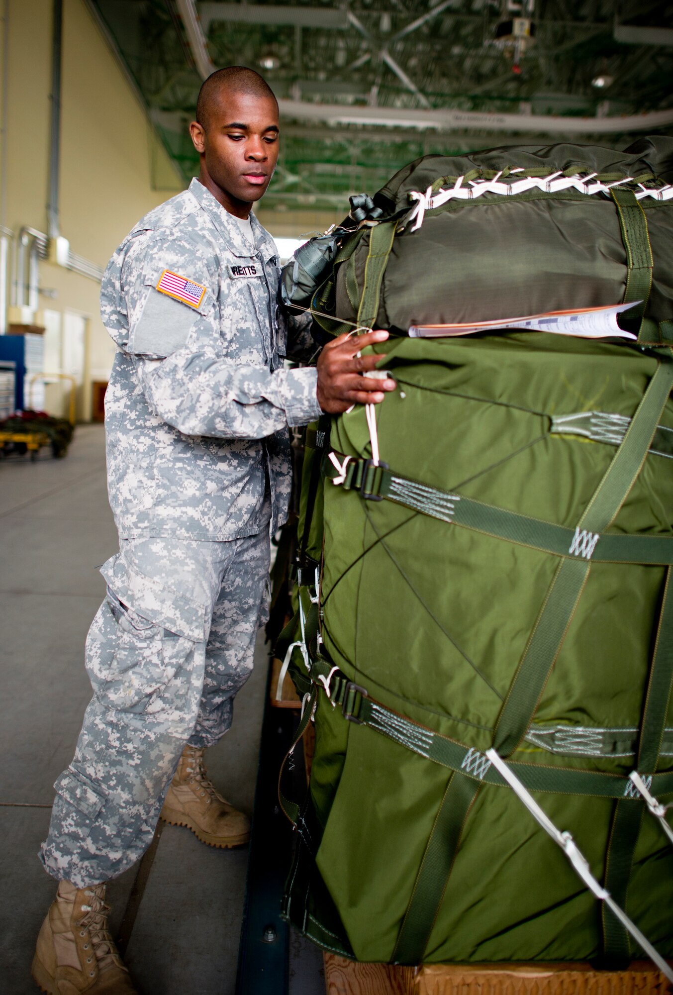 YOKOTA AIR BASE, Japan -- Sgt. Rasheen Threatts, 4th Quartermaster Detachment, Joint Base Elmendorf-Richardson, Alaska, pushes a low velocity container delivery systems on to a Halverson 25K loader May 29, 2013 at Yokota Air Base, Japan. Threatts along with other members from joint services are at Yokota for Airborne Tomahawk, a training exercise to evaluate rigging and movement procedures and execute airdrop resupply. (U.S. Air Force photo by Staff Sgt. Stacy Moless)  