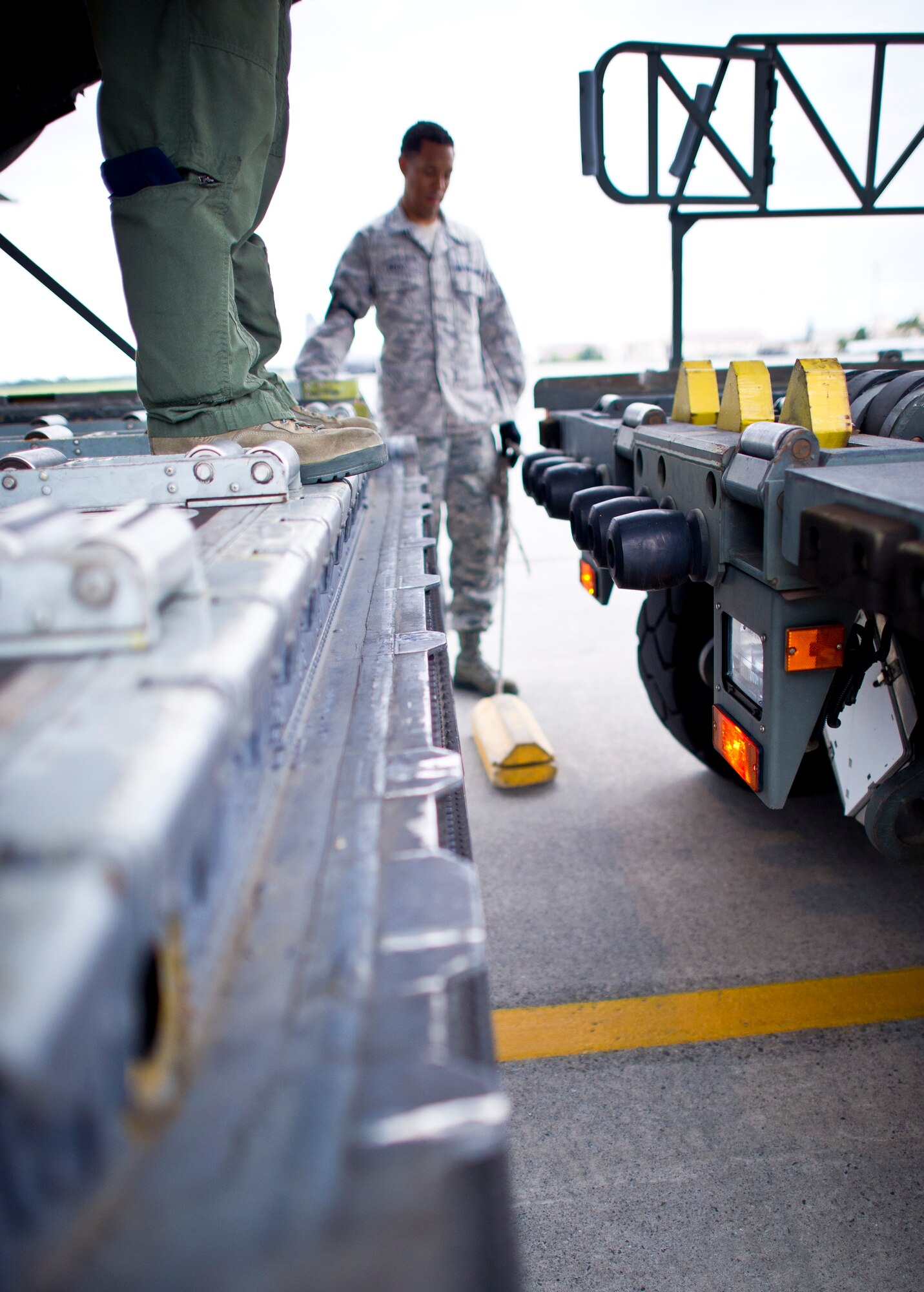 YOKOTA AIR BASE, Japan -- Staff Sgt Chris Nichols, loadmaster with the 36th Airlift Squadron, guides the Halverson 25K loader to the back of a C-130 May 29, 2013 at Yokota Air Base, Japan. The Halverson 25K loader is carrying low cost low altitude bundles to load on the aircraft during training exercise Airborne Tomahawk. (U.S. Air Force photo by Staff Sgt. Stacy Moless)     