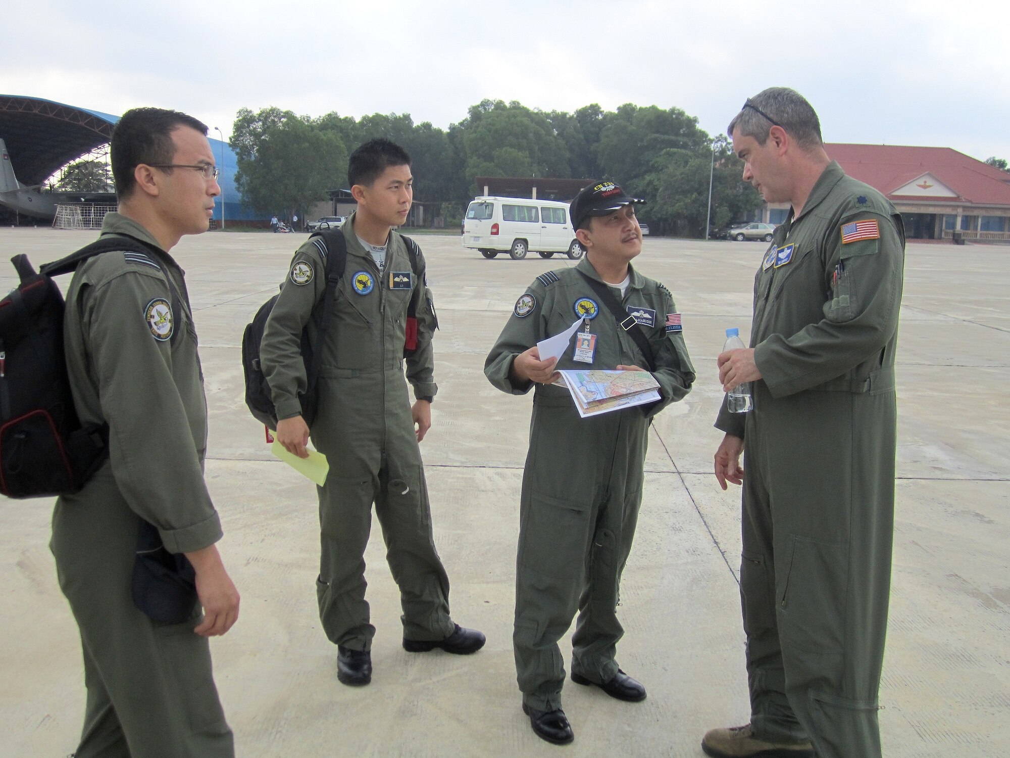 POCHENTONG AIR BASE, Cambodia -- Lt. Col. Tim Murphy, a C-130 pilot with the North Carolina Air National Guard, speaks with his aircrew counterparts from the Royal Malaysian Air Force prior to the first flights of Pacific Airlift Rally 2013 here June 3, 2013. U.S. servicemembers are participating in PAR13, which advances military airlift interoperability and cooperation between the nations of the Indo-Pacific region. The event focuses on planning and practicing advanced military airlift interoperability among regional air forces in support of multilateral humanitarian assistance/disaster relief operations unique to the region. (U.S. Air Force photo/Capt. Chris Hoyler)