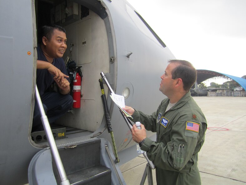 POCHENTONG AIR BASE, Cambodia -- Maj. Jimmy Morris, a C-130 pilot with the North Carolina Air National Guard, speaks with an airman from the Royal Malaysian Air Force prior to the first flights of Pacific Airlift Rally 2013 here June 3, 2013. PAR13 is a biennial, military airlift symposium sponsored by U.S. Pacific Air Forces for nations in the Indo-Pacific region. U.S. servicemembers are participating in PAR13, which advances military airlift interoperability and cooperation between the nations of the Indo-Pacific region.  (U.S. Air Force photo/Capt. Chris Hoyler)