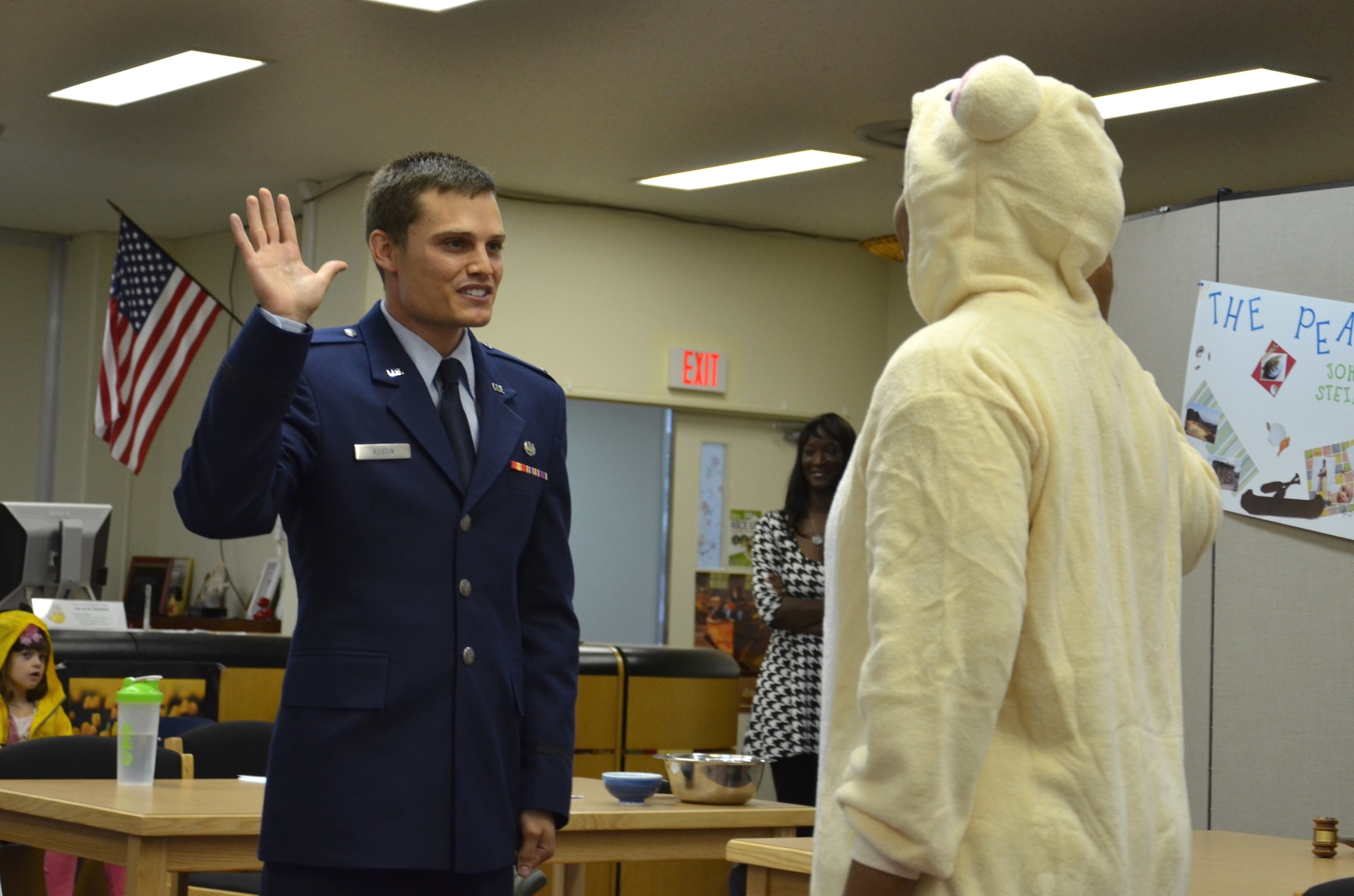 U.S. Air Force 1st. Lt Josh Austin, 18th Wing judge advocate, as prosecutor swears in Mama Bear, played by Tech. Sgt. Rosemarie Thames, 18th Wing paralegal, during a mock trial at Kadena Middle School on Kadena Air Base, Japan, May 23, 2013. The trial was held in honor of Law Day. (U.S. Air Force photo by Senior Master Sgt. Daniel Kazumura/Released)
