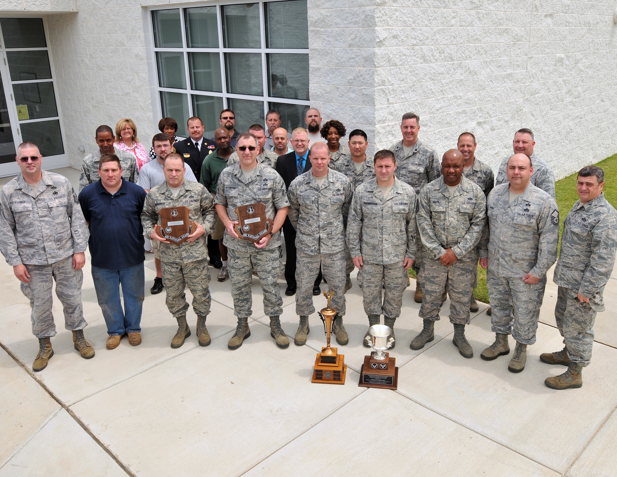 U.S. Air Force Chief Master Sgt. Dan Eakman,  ANG Civil Engineer Career Field Manager and Air Force Col. Peter “Puck” Sartori, Director of Installations and Mission Support and The Civil Engineer for the Air National Guard at Joint Base Andrews, Maryland, pose with military and civilian members of the 145th Civil engineering Squadron after they were presented with the Society of America Military Engineers Curtain Award for Air Force Outstanding Unit of the Year, the Col. Fredrick J. Riemer Award, for ANG Outstanding Readiness & Emergency Management Flight and  Col. William L. Deneke Award for Outstanding Unit of the Year Award.  These annual awards recognize the best CE squadron from all Air Reserve components in the United States that best demonstrates exemplary performance in support of the engineer readiness mission. The ceremony was held on May 16, 2013, at the North Carolina Air National Guard base in Charlotte, N.C.   (U.S. Air National Guard photo by Tech. Sgt. Patricia Findley/Released)