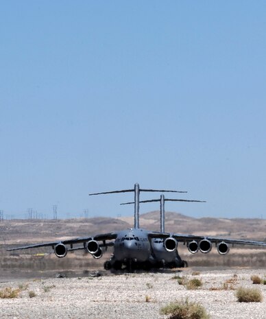 C-17 Globemaster IIIs that participated in the Joint Forcible Entry Exercise taxi to park May 31, 2013, at Nellis Air Force Base, Nev. JFEX is a U.S. Air Force Weapons School large-scale air mobility exercise that tests participants’ ability to synchronize aircraft movements from geographically separated bases. (U.S. Air Force photo by Tech. Sgt. Taylor Worley)