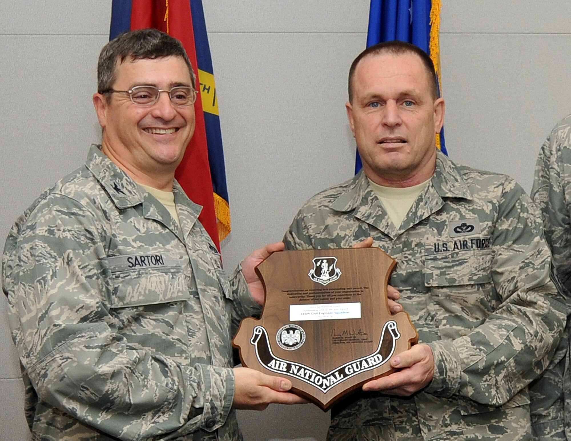 On May 16, 2013, Air Force Col. Peter “Puck” Sartori, Director of Installations and Mission Support and The Civil Engineer for the Air National Guard at Joint Base Andrews, Maryland, visited the 145th Airlift Wing, North Carolina Air National Guard base to present the Colonel William L. Deneke Award, National Guard Bureau/A7 Outstanding Unit of the Year, to Chief Master Sgt. Tom Hunsucker, Regional Training Site Enlisted Manager for the 145th Civil Engineering Squadron. This annual award is in recognition of the most outstanding CE Air Reserve Component unit. The criteria to be honored with this award are showing the greatest achievement and exemplary performance in Expeditionary Engineering, Installation Engineering, Environmental Leadership, Emergency Service and Training Excellence. 
(U.S. Air National Guard photo by Tech. Sgt. Patricia Findley/Released)
