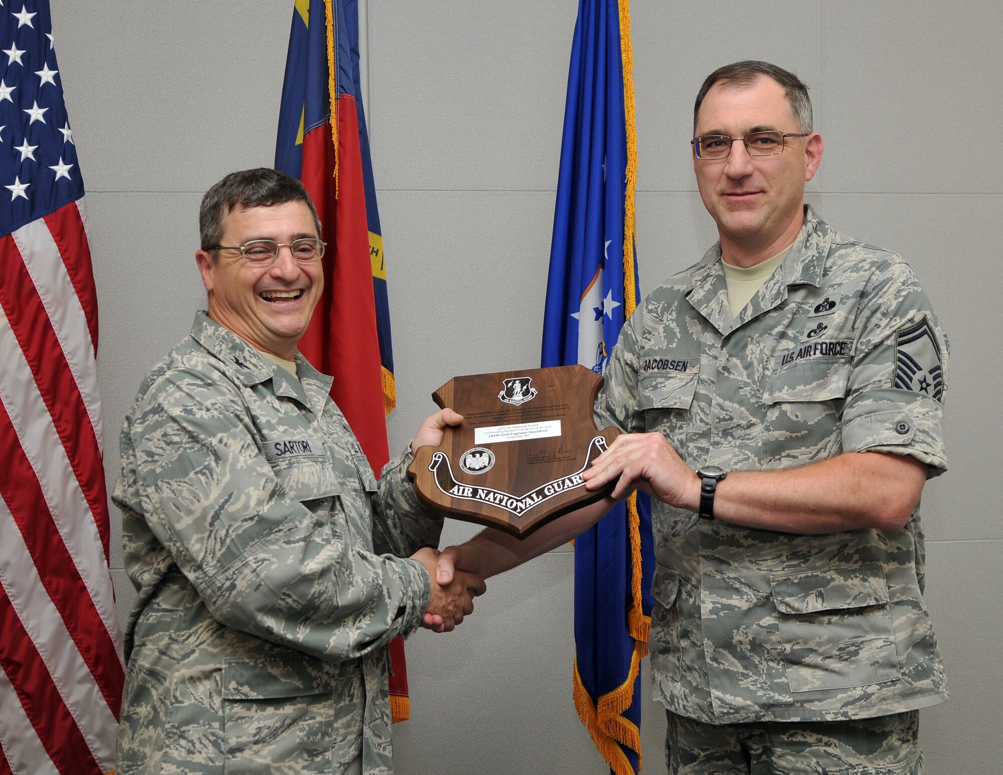 On May 16, 2013, Air Force Col. Peter “Puck” Sartori, Director of Installations and Mission Support and The Civil Engineer for the Air National Guard at Joint Base Andrews, Maryland, visited the 145th Airlift Wing, North Carolina Air National Guard base to present the Colonel Fredrick J. Riemer Award to Senior Master Sgt. Kenneth Jacobson, Emergency Management Flight Superintendent, 145th Civil Engineering Squadron. This annual award is in recognition of the best CE Readiness Flight from all Air Reserve components in the United States that best demonstrates exemplary performance in support of the engineer readiness mission. (U.S. Air National Guard photo by Tech. Sgt. Patricia Findley/Released)
