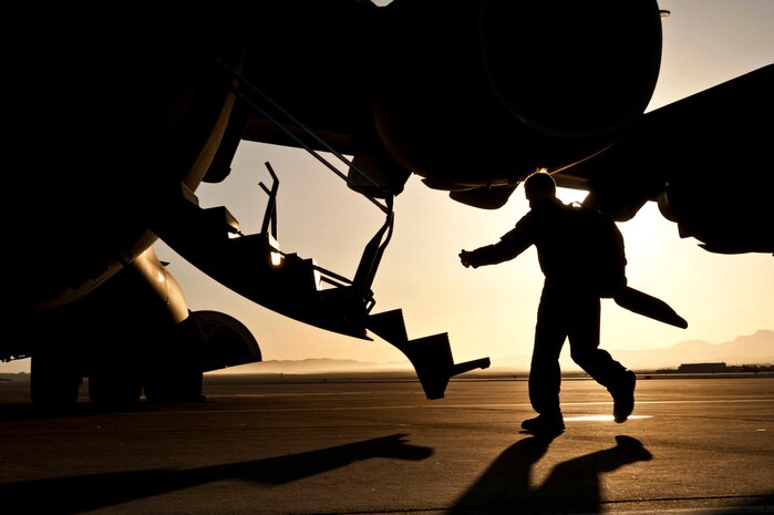 U.S. Air Force Maj. Nathan Hangerman, 57th Weapons Squadron pilot, boards a C-17 Globemaster from McChord Air Force Base, Wash., as an instructor during a Joint Forcible Entry exercise May 31, 2013, at Nellis Air Force Base, Nev.  JFEX is a US Air Force Weapons School large-scale air mobility exercise in which participants plan and execute a complex air-land operation in a simulated contested battlefield. (U.S. Air Force photo by Senior Airman Daniel Hughes)