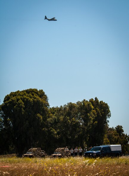 A MC-130P Combat Shadow Aircraft assigned with the 130th Rescue Squadron flys above Pararescuemen and trainees with the 131st Rescue Squadron during  training on High Altitude Low Opening (HALO) parachute techniques above Moffett Federal Airfield, Calif., on June 2, 2013.  Pararescuemen are highly skilled at many advanced tactics that allow them to rescue distressed people and downed air crews anywhere in the world.  (U.S. California Air National Guard Photo by Senior Airman John D. Pharr III/Released)
