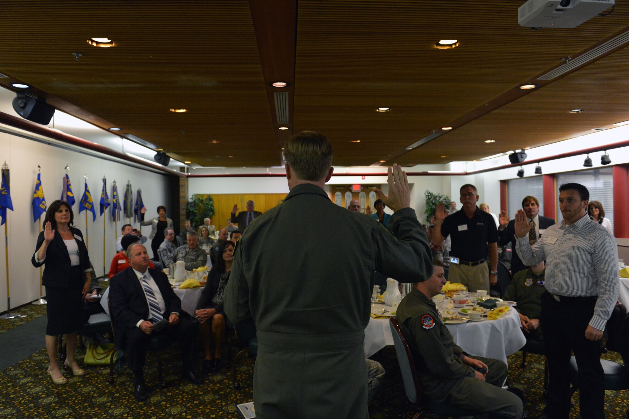 Col. Wyn Elder, 62nd Airlift Wing commander, administers the Honorary Commanders oath May 31, 2013, at Joint Base Lewis-McChord, Wash. The oath formally inducts key civic leaders into the position of honorary commander and symbolizes the partnership they are about to enter with the 62nd AW and Airmen. (U.S. Air Force photo/Staff Sgt. Jason Truskowski)
