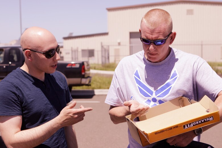 Airman 1st Class Rafe Holmes, 72nd Security Forces Squadron, explains how he found the property of Master Sgt. Jerry Colbaugh while volunteering after the May 20 tornado struck Moore, Okla. Colbaugh’s home was destroyed in the storm that killed 24 people, including 10 children. (U.S. Air Force photo by Staff Sgt. Caleb Wanzer)