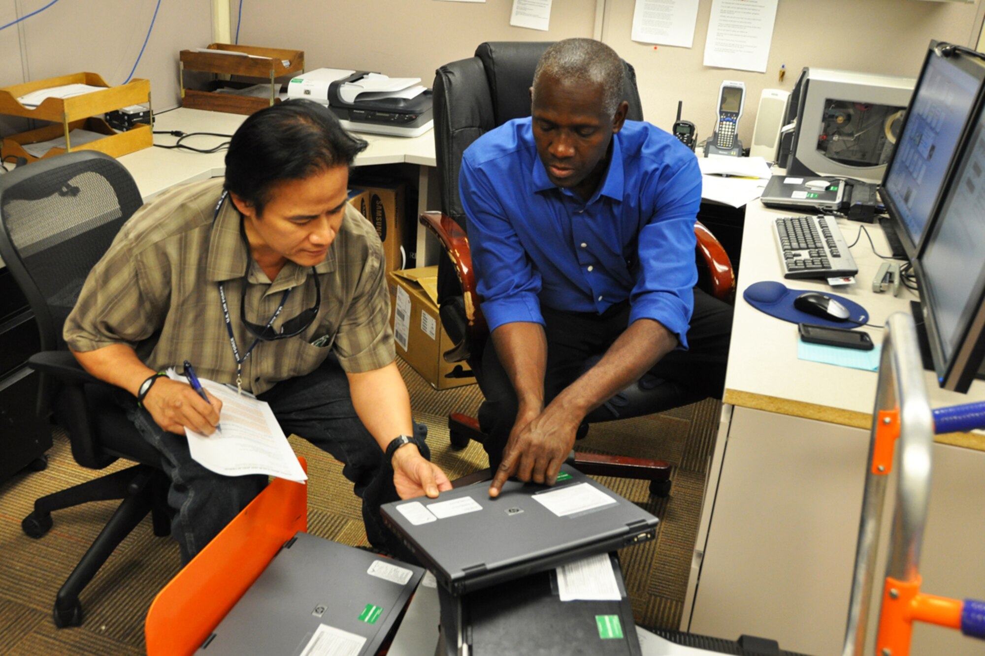 Mario Manera, alternate base equipment control officer and Bernard Parkinson, primary ECO, inventory equipment that is due for tech refresh May 30. The ECOs manage unit Information Technology Equipment Custodians, act as the liaisons between major command ECOs and their home station, oversee and manage the base inventory program, and ensure all annual unit IT inventories are completed and signed off by the wing commander before the required deadline. Dobbins’ ITEC inventory compliance went from last fiscal year’s 61 percent to 100 percent, the largest improvement in Air Force Reserve Command. (U.S.Air Force photo/James Branch)