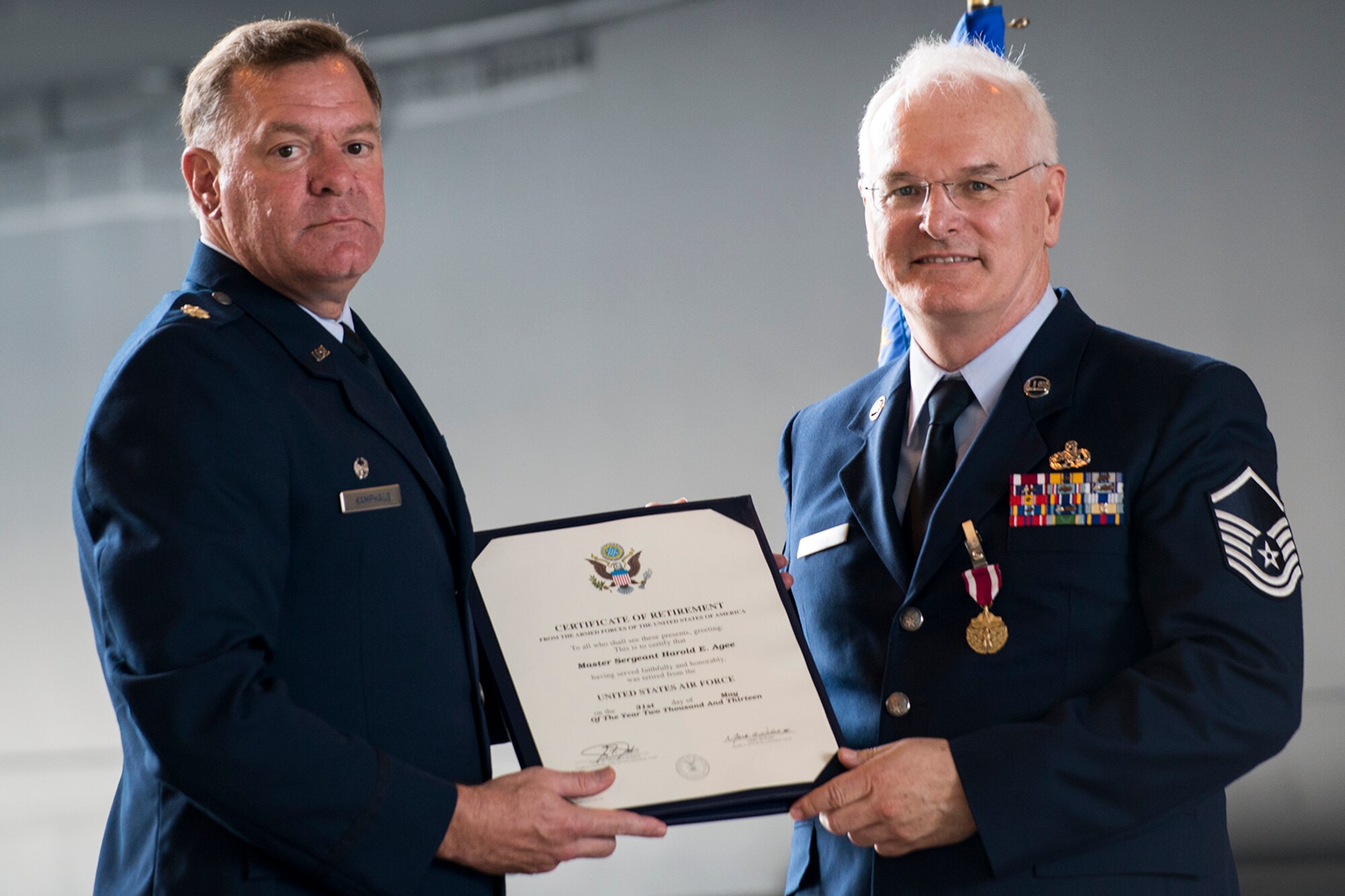 U.S. Air Force Maj. Leo Kamphaus, 307th Maintenance Squadron commander, presents the Certificate of Retirement to Master Sgt. Harold Agee during a retirement ceremony, May 31, 2013, Barksdale Air Force Base, La. Agee is retiring from the Air Force Reserve after 35 years of service. (U.S. Air Force photo by Master Sgt. Greg Steele/Released)