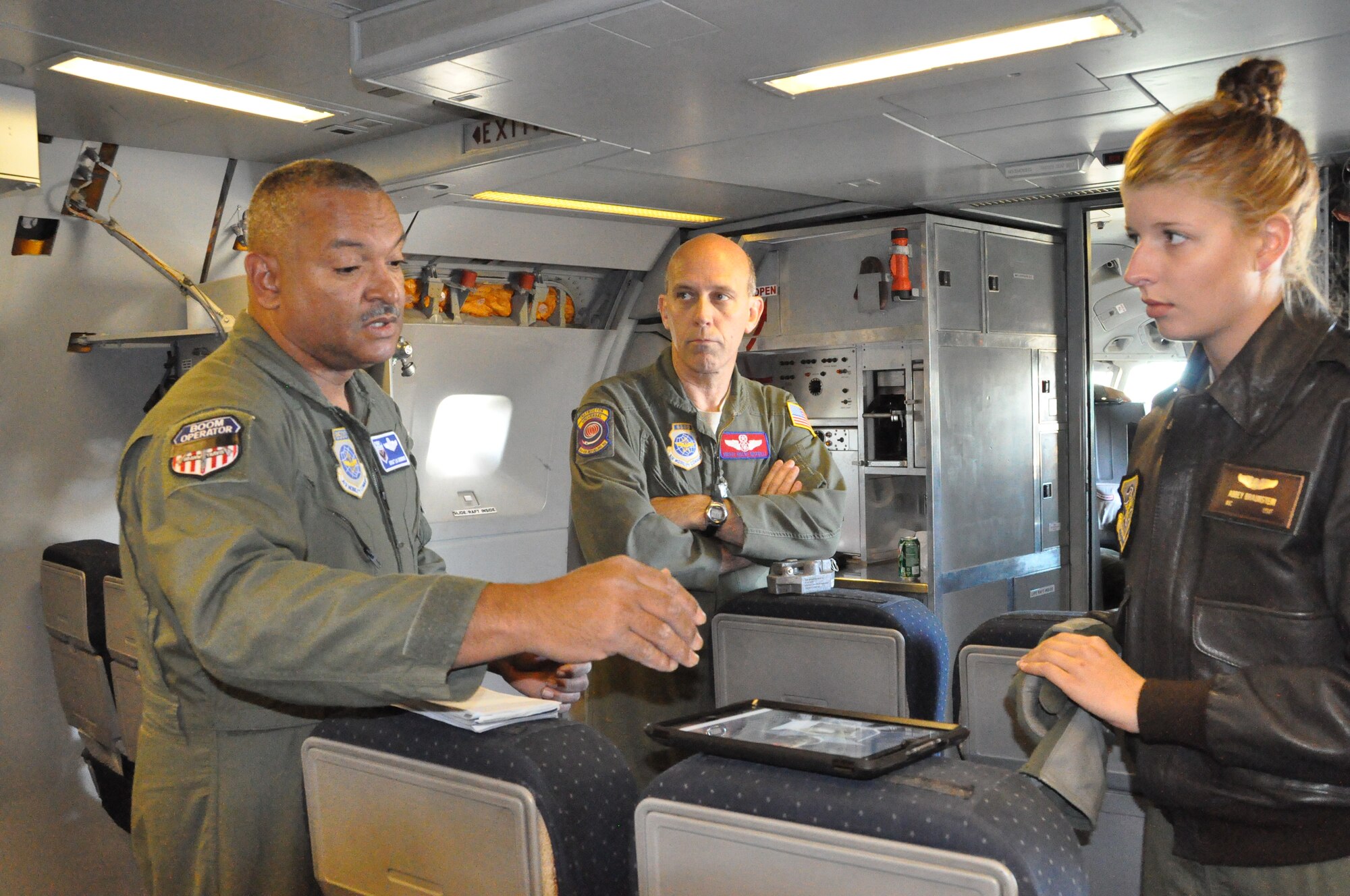 Chief Master Sgt. Luis Drummond, 60th Operations Group superintendent, mentors Airman 1st Class Abbey Braunstein, 6th Air Refeuling Squadron boom operator, and reviews plans for refuleing on their flight. (U.S. Air Force Photo/2nd Lt. Jessica Clark)