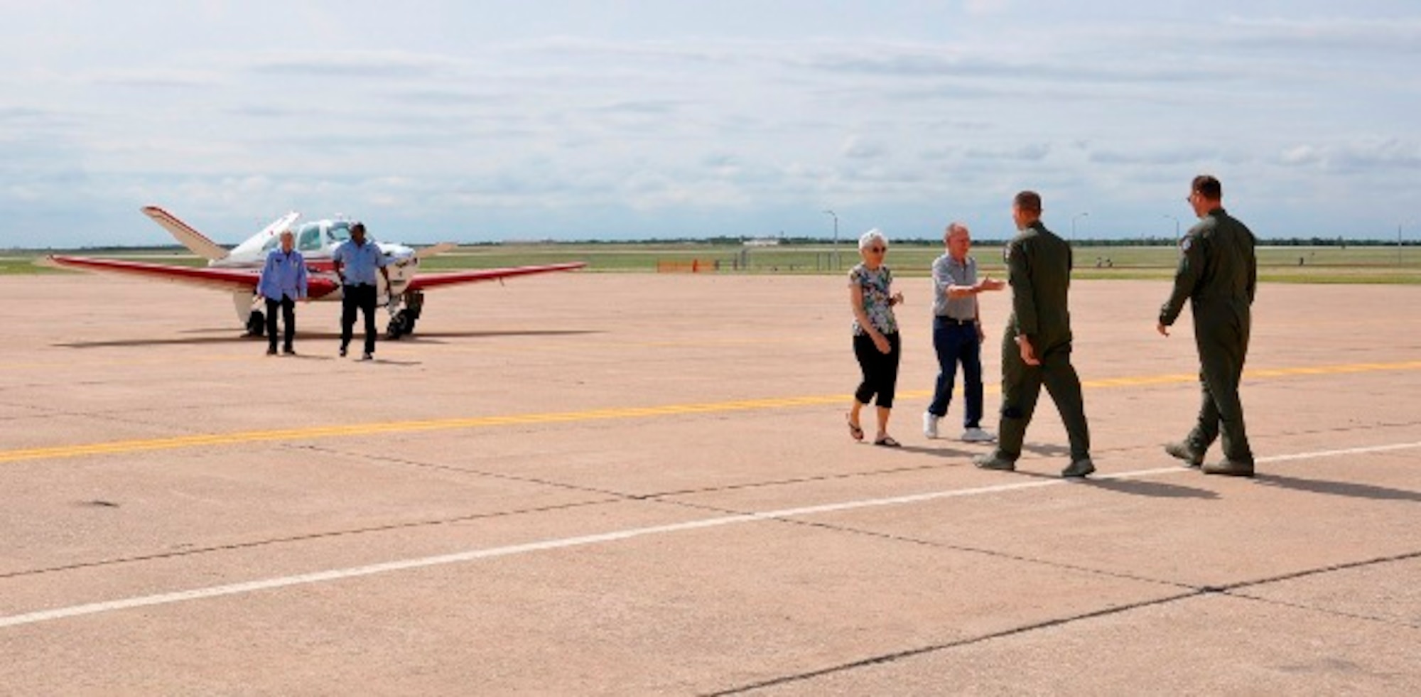 Mr. Glenn and Mrs. Bonnie Beavers of Beavers Aircraft Management in Wichita Falls, Texas, greet Colonel Lance Bunch, 80th Flying Training Wing commander, and Major Cameron Curry, 80th Operations Wing safety officer, upon arrival for the 80th Flying Training Wing's 'Share the Air' Civilian Fly-In June 1, 2013 at Sheppard Air Force Base, Texas. (U.S. Air Force photo/Debi Smith)