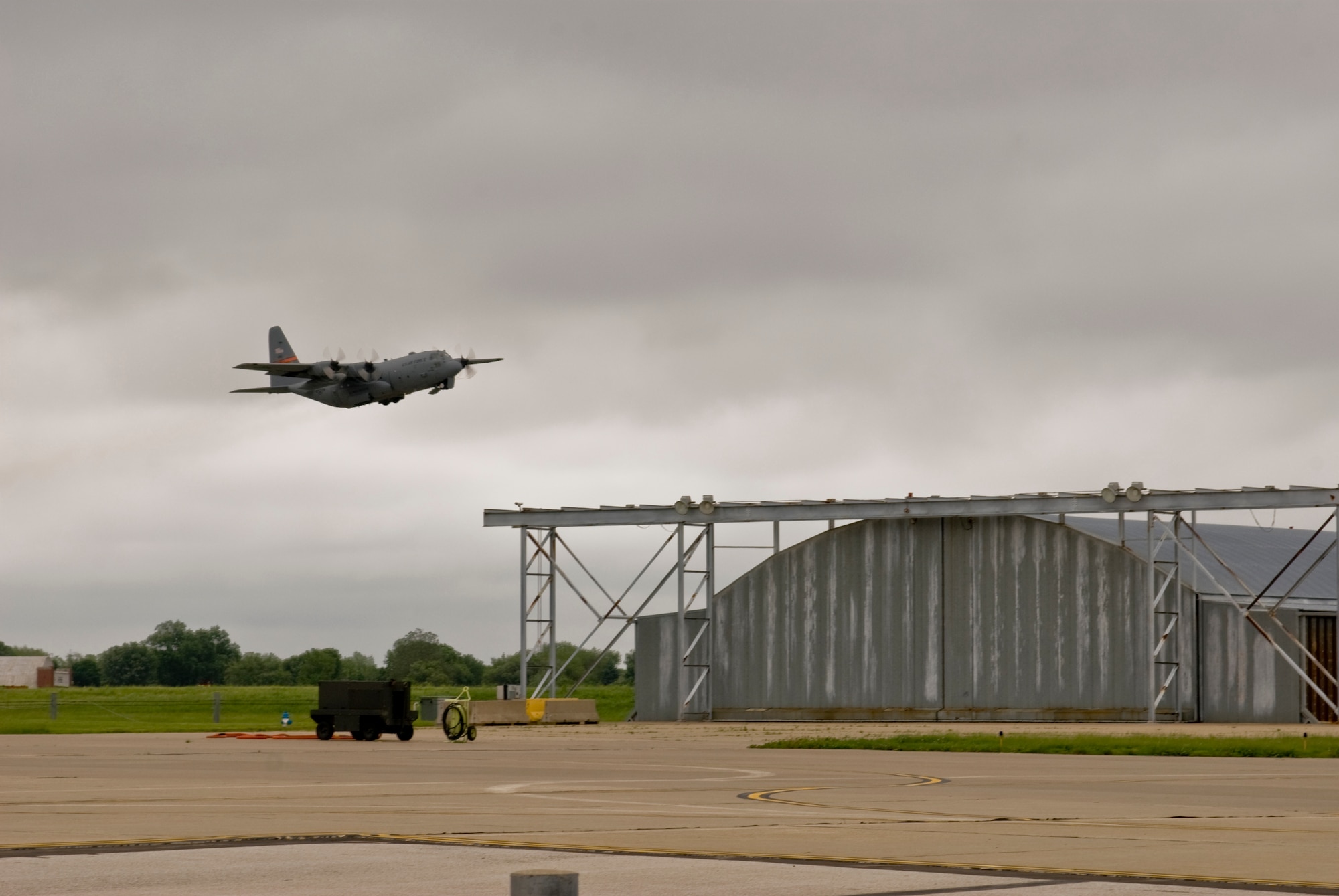 An Illinois Air National Guard C-130H3 Hercules aircraft takes flight over the 182nd Airlift Wing in Peoria, Ill., June 2, 2013.  The military transport plane participated in a rare seven-ship taxi in which seven aircraft from the Air National Guard base flew together simultaneously in formation.  (U.S. Air National Guard photo by Staff Sgt. Lealan Buehrer/Released)