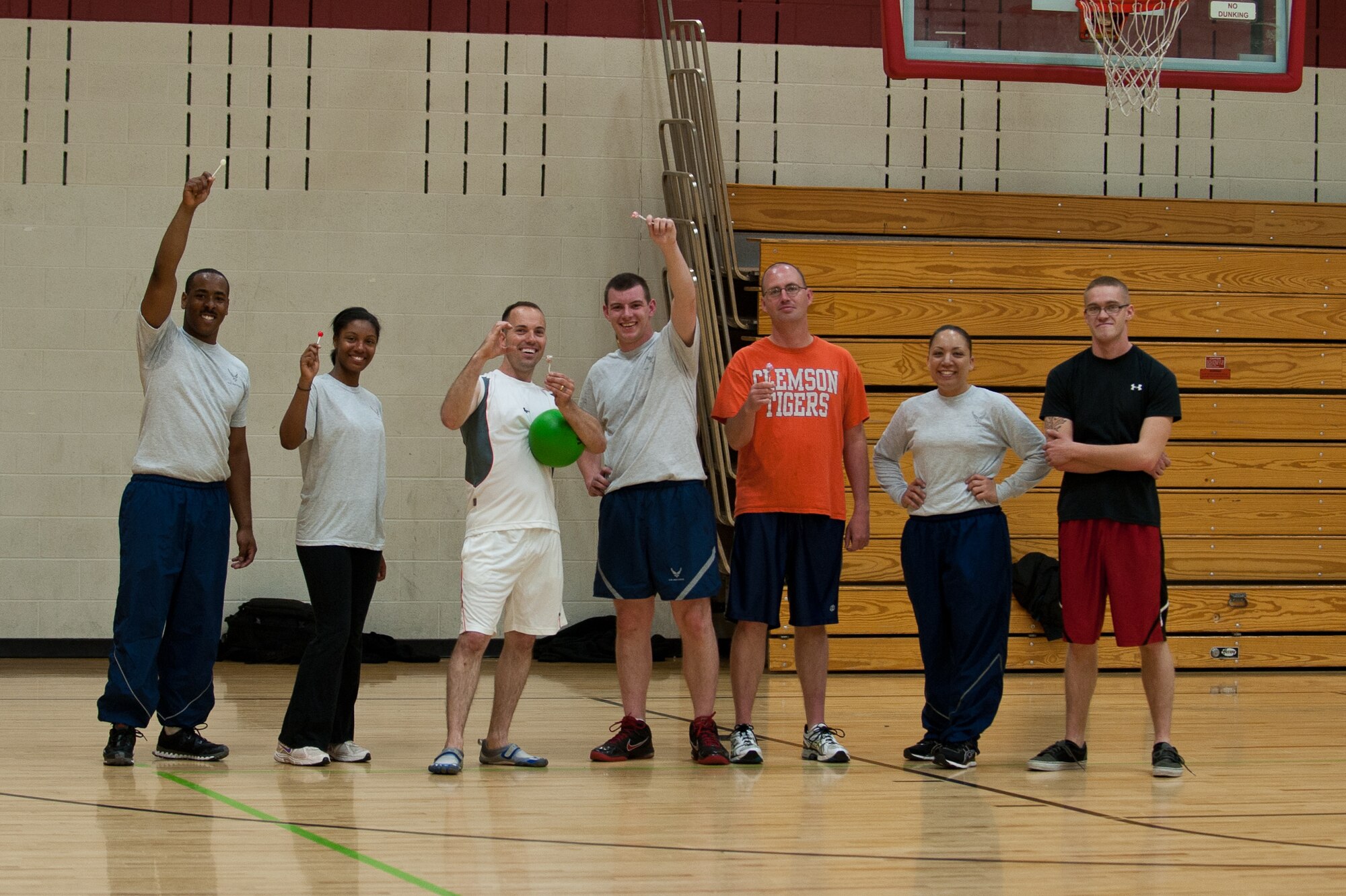 The 28th Maintenance Squadron Aerospace Ground Equipment section Airmen hoist their first-place prizes after winning a lunchtime dodgeball tournament at the Bellamy Fitness Center on Ellsworth Air Force Base, S.D., May 21, 2013. The winning team received lollipops for their victory in the tournament as part of fitness month. (U.S. Air Force photo by Airman 1st Class Alystria Maurer/Released)