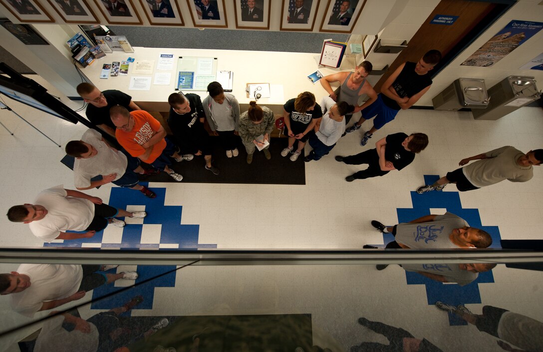 Participants gather at the front desk of the Bellamy Fitness Center prior to the start of the lunchtime dodgeball tournament on Ellsworth Air Force Base, S.D., May 21, 2013. The 28th Force Support Squadron organized several events throughout May as part of fitness month to help promote fitness and healthy competition. (U.S. Air Force photo by Airman 1st Class Alystria Maurer/Released)