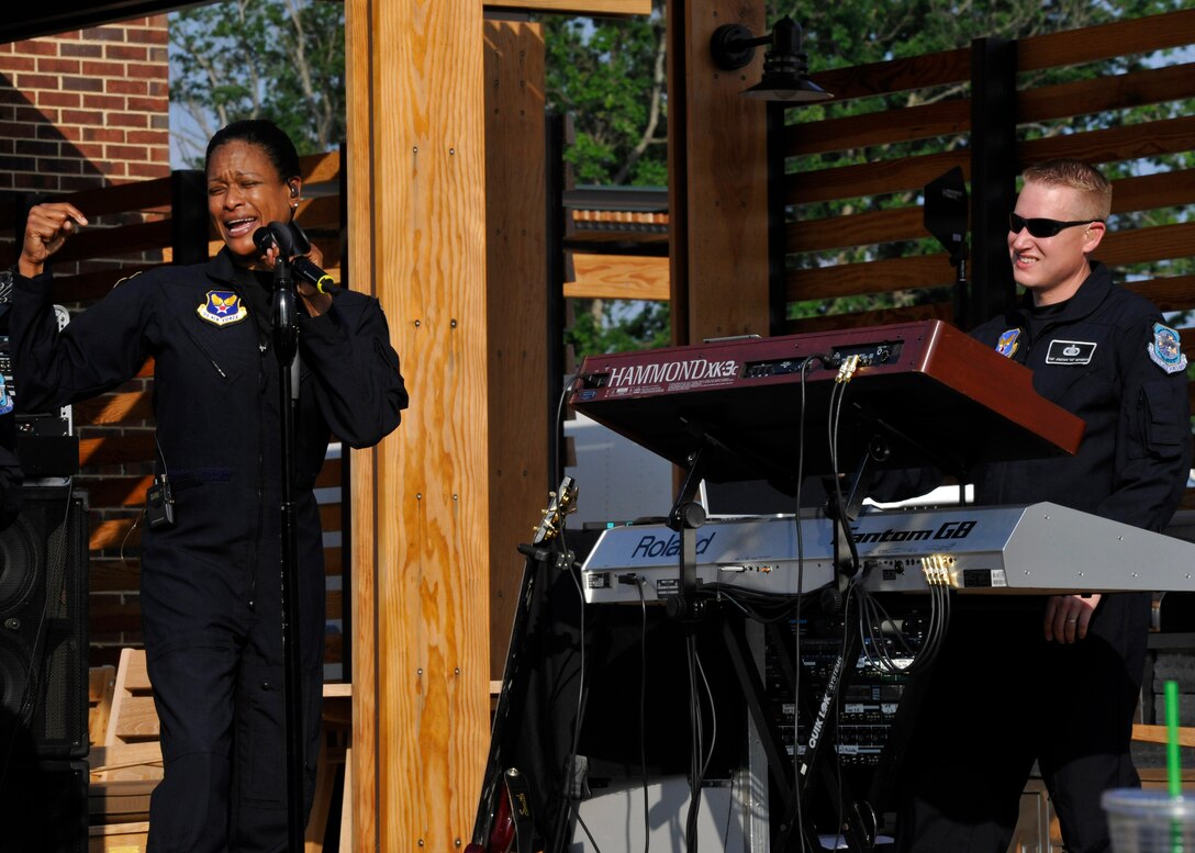 Master Sgt. Shani Prewitt, left, Max Impact vocalist, and Master Sgt. Jonathan McPherson, Max Impact pianist, entertain the crowd during a free community-wide barbecue at the newly-opened USO Warrior and Family Center on Ft. Belvoir, Va., May 22, 2013. The center hosted the cookout in order to garner awareness of future USO events. (U.S. Air Force photo/Senior Airman Lindsey A. Porter)