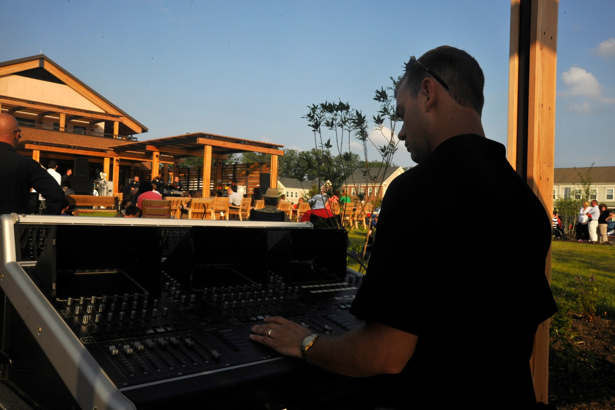 Tech. Sgt. Chad J. Randolph, Max Impact audio engineer, assists The U.S. Air Force Band's premiere rock ensemble during their set at the newly-opened USO Warrior and Family Center on Ft. Belvoir, Va., May 22, 2013. Max Impact performed at the newly-opened center in conjunction with a free community-wide barbecue in order to garner awareness of future USO-sponsored events. (U.S. Air Force photo/Senior Airman Lindsey A. Porter)