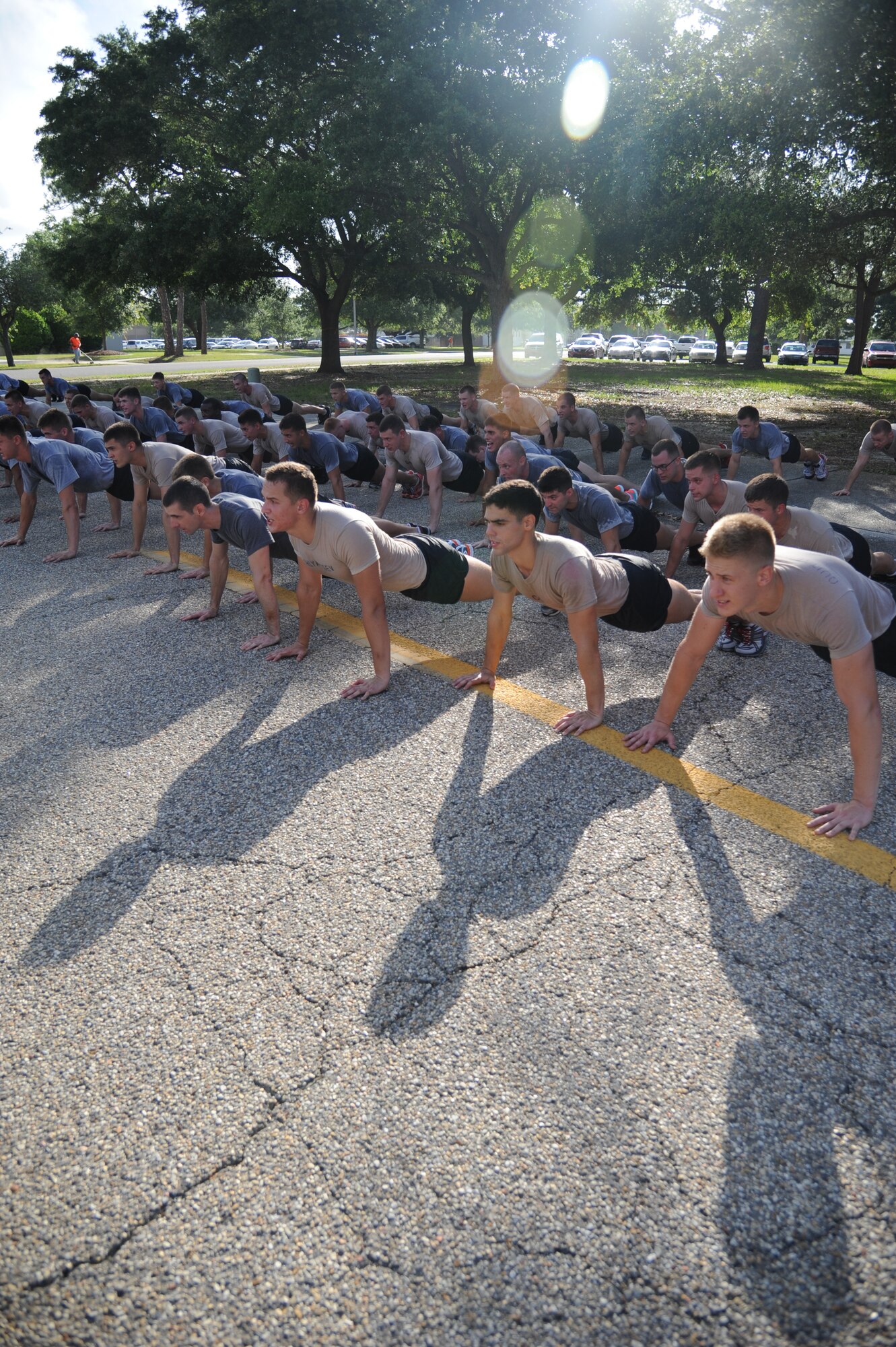 Airmen from the 81st Training Group do memorial push-ups as they conclude a memorial physical training session May 31, 2013, at Keesler Air Force Base, Miss.  The three-day PT event was in memory of three combat controllers who lost their lives on Memorial Day 2005 in Iraq.  (U.S. Air Force photo by Kemberly Groue)