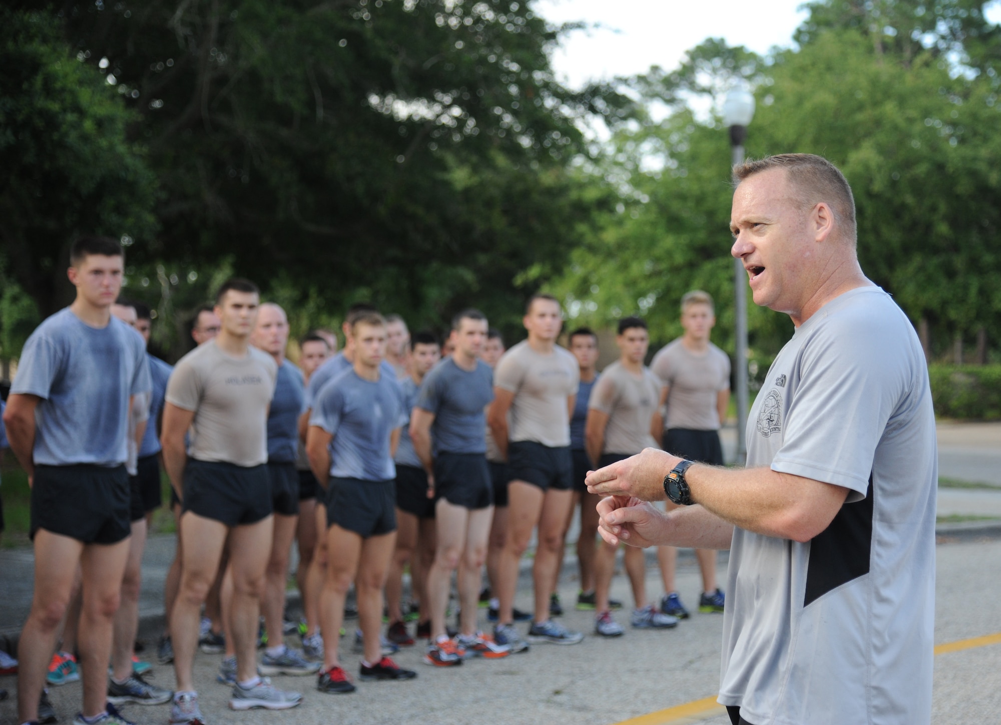 Senior Master Sgt. Bradley Reilly, 334th Training Squadron combat controller instructor, speaks to Battlefield Airmen from the 81st Training Group as they conclude a memorial physical training session May 31, 2013, at Keesler Air Force Base, Miss.  The three-day PT event was in memory of three combat controllers who lost their lives on Memorial Day 2005 in Iraq.  (U.S. Air Force photo by Kemberly Groue)