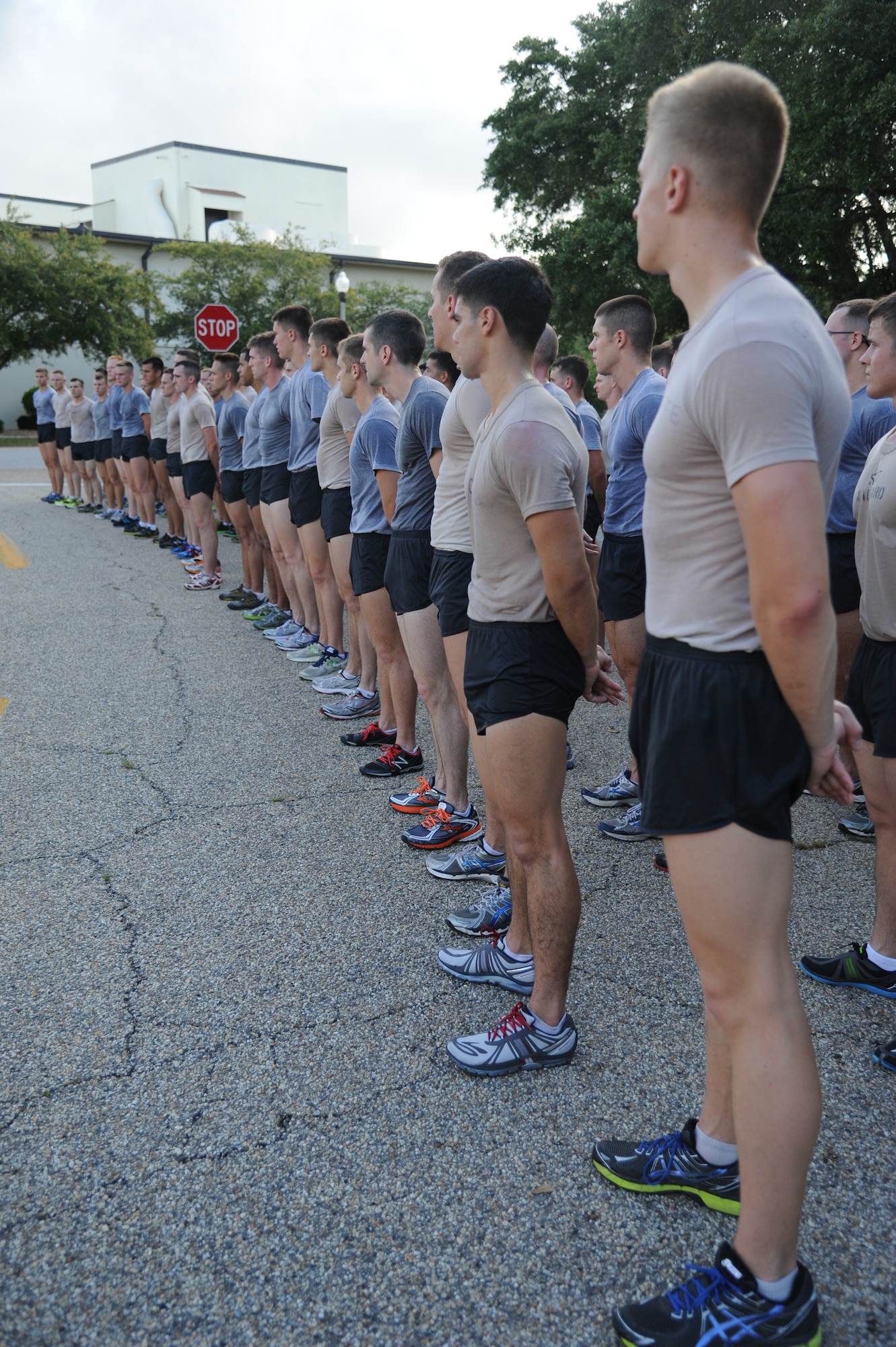 Airmen from the 81st Training Group stand in formation in front of the 81st Training Wing headquarters building as they conclude a memorial physical training session May 31, 2013, at Keesler Air Force Base, Miss.  The three-day PT event was in memory of three combat controllers who lost their lives on Memorial Day 2005 in Iraq.  (U.S. Air Force photo by Kemberly Groue)