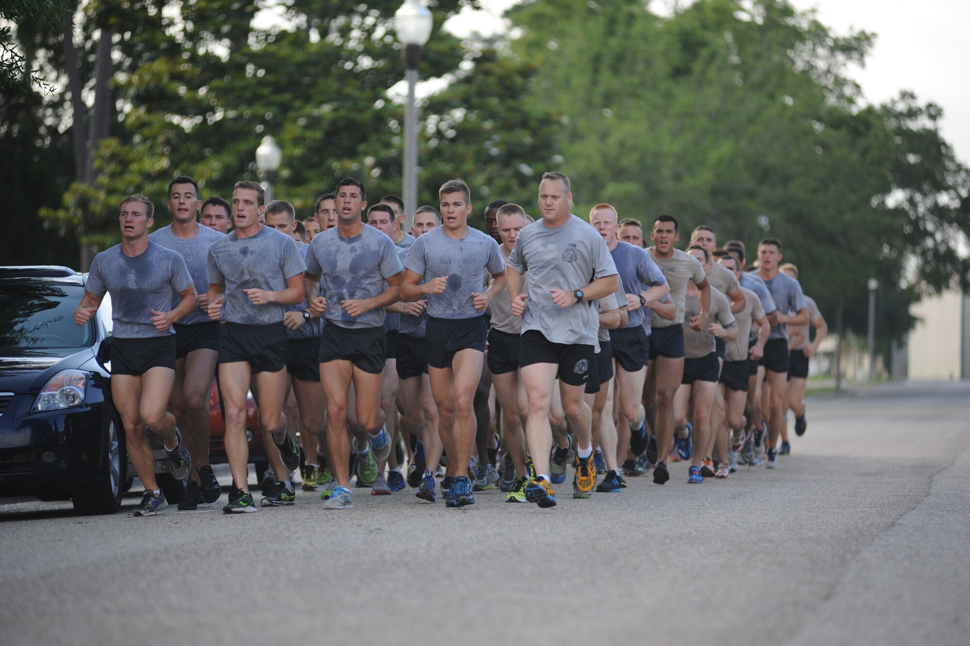 Airmen from the 81st Training Group run in formation down Chappie James Avenue during a memorial physical training session May 31, 2013, at Keesler Air Force Base, Miss.  The three-day PT event was in memory of three combat controllers who lost their lives on Memorial Day 2005 in Iraq.  (U.S. Air Force photo by Kemberly Groue)