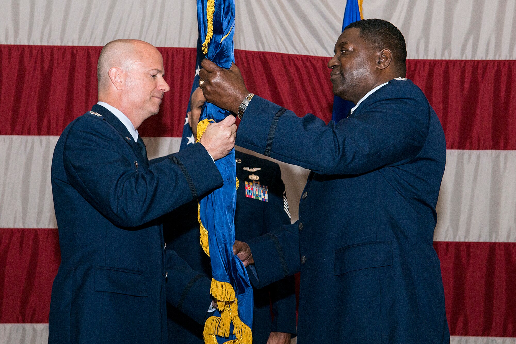 U.S. Air Force Col. Jonathan Ellis, 307th Bomb Wing commander, presents the 307th Mission Support Group guidon to Col. Roy Peterson during a Change of Command ceremony, June 1, 2013, Barksdale Air Force Base (AFB), La. Peterson is the former commander of the 908th Mission Support Group, 908th Airlift Wing, Maxwell AFB, Ala. (U.S. Air Force photo by Master Sgt. Greg Steele/Released)