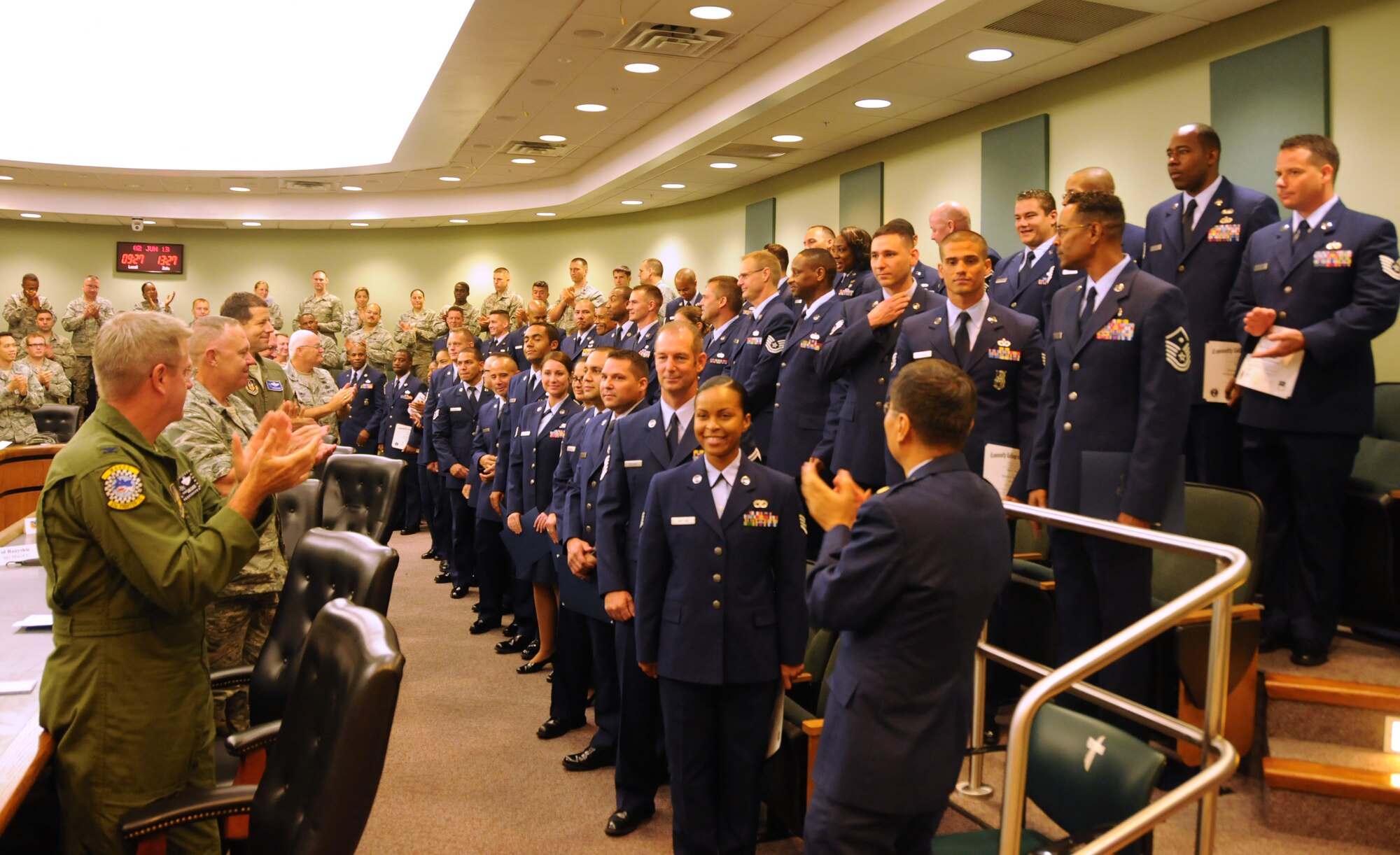 Recent Community College of the Air Force graduates receive a round of applause during a graduation ceremony at Homestead Air Reserve Base, Fla., June 2. (U.S. Air Force photo/Senior Airman Nicholas Caceres, 482nd Fighter Wing Public Affairs)