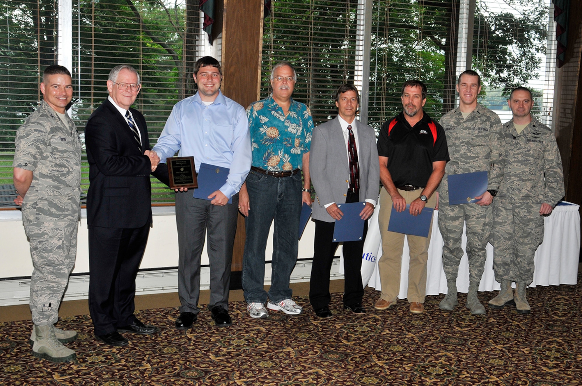 Pictured here is AEDC Commander Col. Raymond Toth (far left) and Dr. Bill Baker (2nd from left) presenting the AIAA Special Award to the C-5M AEDC test team who include: (l-r) Calin Schuman, Marvin Sellers, Dr. Don Malloy, John Hopf, 1st Lt. Joshua Coughenour and Lt. Col Leland Davis. Test team members not present at the time of the photo are Capt. John Labouliere, David Yoder, Rolland Heim, Melissa Minter, Darhl Frazier, Sherry Simons, Scott Wieland, Brent Rodgers and Paul Jalbert. (Photo by Rick Goodfriend)