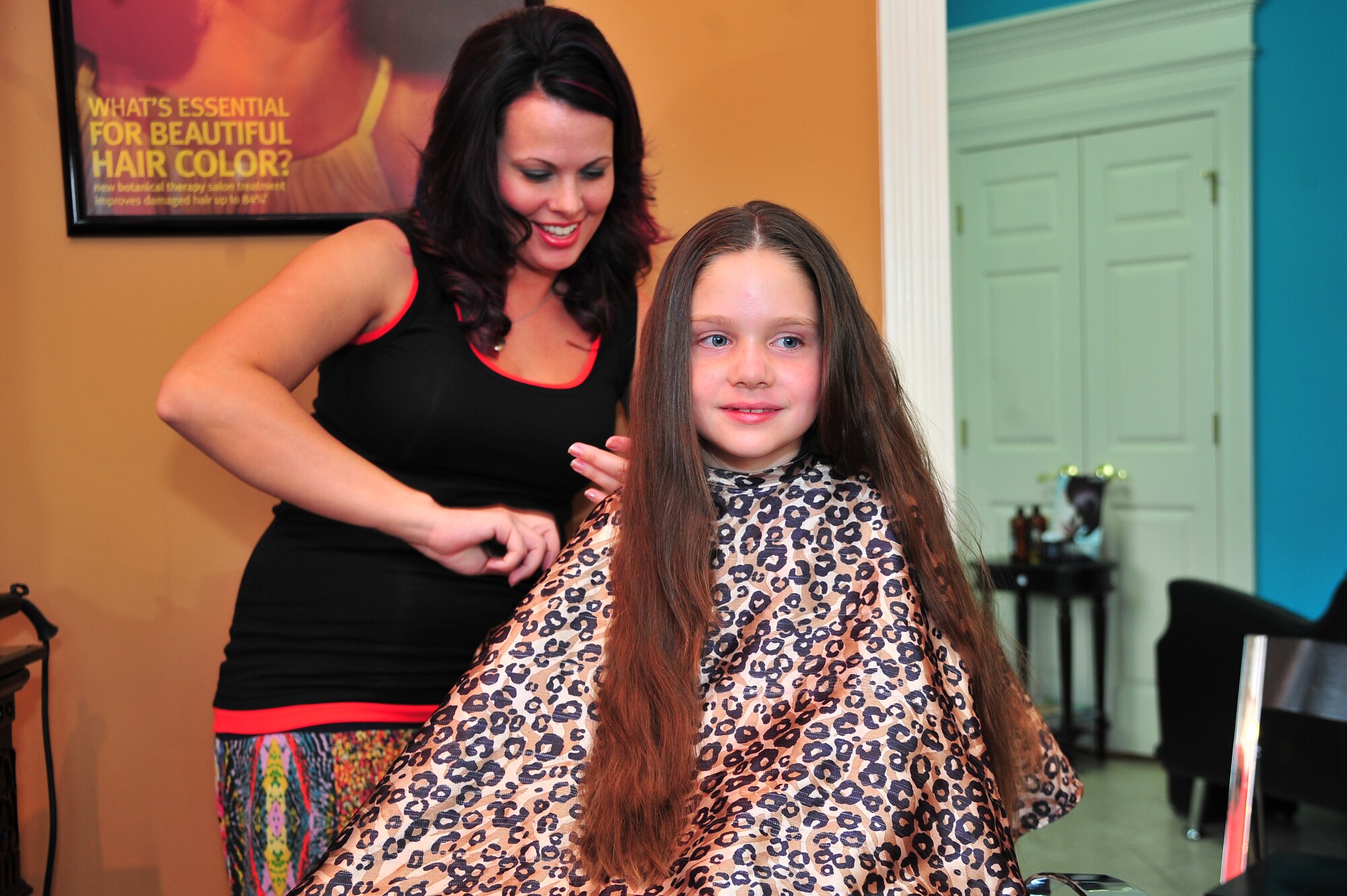 Cassandra Kinsley, senior stylist, prepares to cut Shannon Leavitt’s, hair for donation at J. L. Eden Salon & Day Spa in Goldsboro, N.C., June 1, 2013. Shannon, 8, daughter of Col. Jeannie Leavitt, 4th Fighter Wing commander, began growing her hair at the age of 6 and donated 12 inches to Wigs for kids, a non-profit organization benefiting children who suffer from hair loss due to medical conditions. (U.S. Air Force photo by Airman 1st Class Aubrey White/Released)