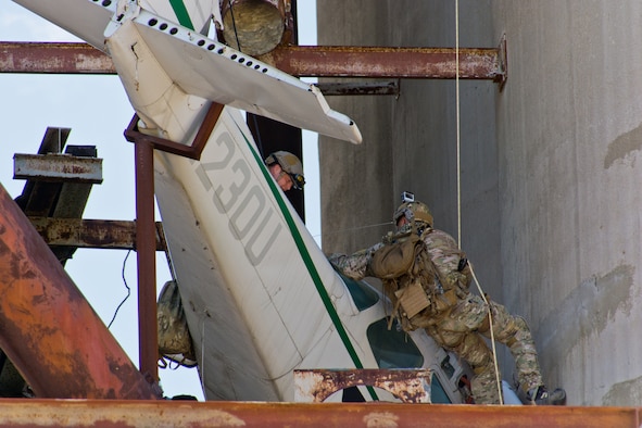 Major David McGraw (left), a Combat Rescue Officer, and SMSgt Robert Bean (right), a Pararescueman, attend to the wrecked airplane at Calamityville.  Photo credit: Mr. Rick Eldridge.