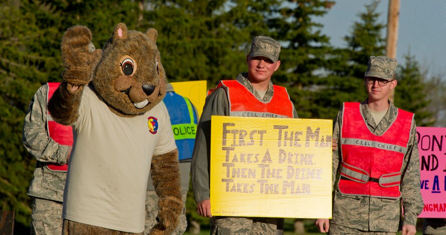 MINOT AIR FORCE BASE, N.D. -- Airmen from the 5th Aircraft Maintenance Squadron participate in a DUI awareness event here, May 23. Volunteers held DUI awareness signs at the base’s south gate for Airmen and families entering and exiting the base to remind them to make wise decisions concerning alcohol use. (U.S. Air Force photo/Senior Airman Brittany Y. Auld)