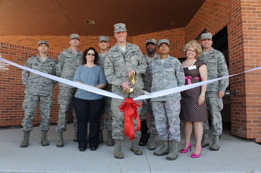 MINOT AIR FORCE BASE, N.D. – Col. Alex Mezynski, 5th Bomb Wing commander, and representatives from the Airmen’s Attic, Base Honor Guard, Cinderella Boutique, Thrift Shop and Linen Exchange, take part in a ribbon cutting ceremony for the Combined Community Complex here, May 22. The CCC offers a new venue for these agencies and a more convenient location for Airmen and their families to locate their services. (U.S. Air Force photo/Airman 1st Class Stephanie Ashley)