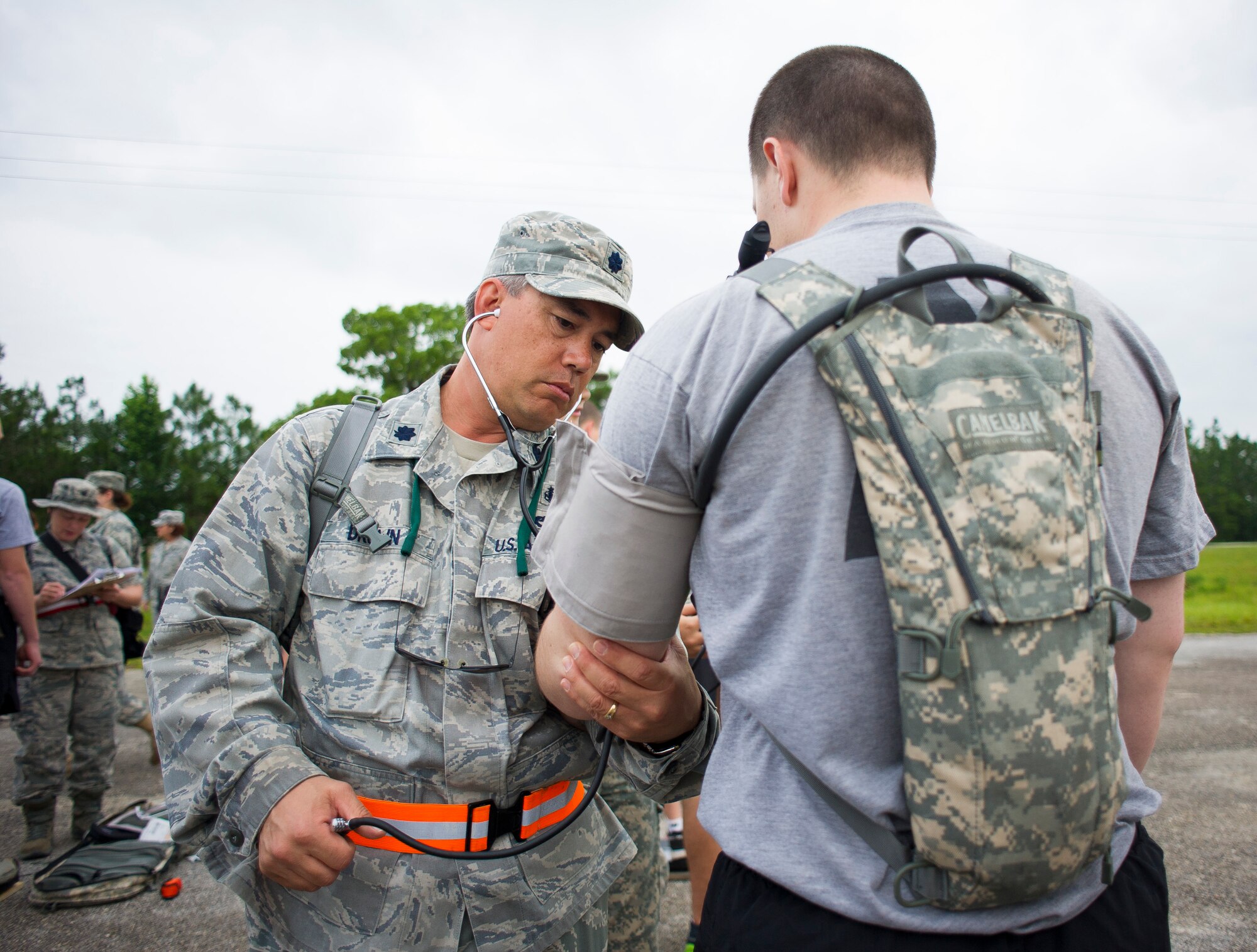 U.S. Air Force Lt. Col. Charles Drown, left, medical element commander with the 165th Medical Group, Georgia Air National Guard, performs a blood pressure reading on a National Guardsman, during the Vigilant Guard 2013 exercise at Camp Blanding, Fla., May 20, 2013.  The Medical Groups from the 116th Air Control Wing and the 165th Airlift Wing are a key component of the 78th Homeland Response Force set up to respond to disasters in the Southeast U.S. region.  During the exercise, Guardsmen responded to various scenarios such as a plane crash, train derailment, hurricane, and an explosion at a chemical plant. (U.S. Air National Guard photo by Master Sgt. Roger Parsons/Released)