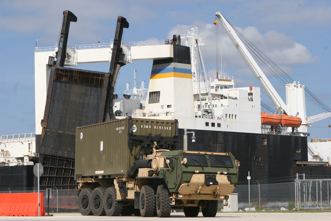 Marines from II Marine Expeditionary Force drive a logistics vehicle system replacement, LVSR, carrying an intermodal container that was offloaded from the United States Naval Ship Dahl during a Marine Prepositioning Force Exercise aboard Marine Corps Support Facility Blount Island, Fla., May 28, 2013. During the exercise, Marines worked in conjunction with sailors to move equipment from the USNS Dahl to designated areas aboard Blount Island. (U.S. Marine Corps photo by Lance Cpl. Shawn Valosin)